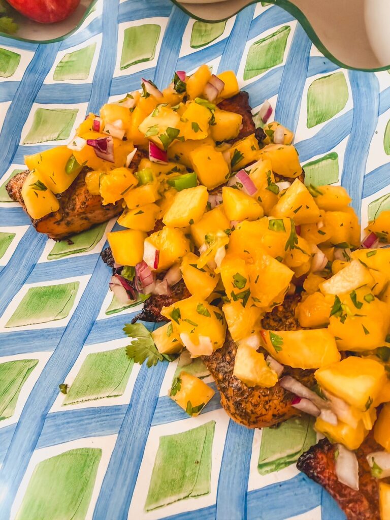 close up of mango peach salsa on top of salmon