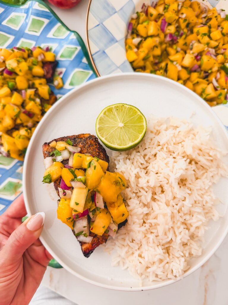 mango peach salsa on salmon with a side of rice
