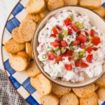 overhead view of bowl of blt dip in center of serving platter surrounded by crostini dippers
