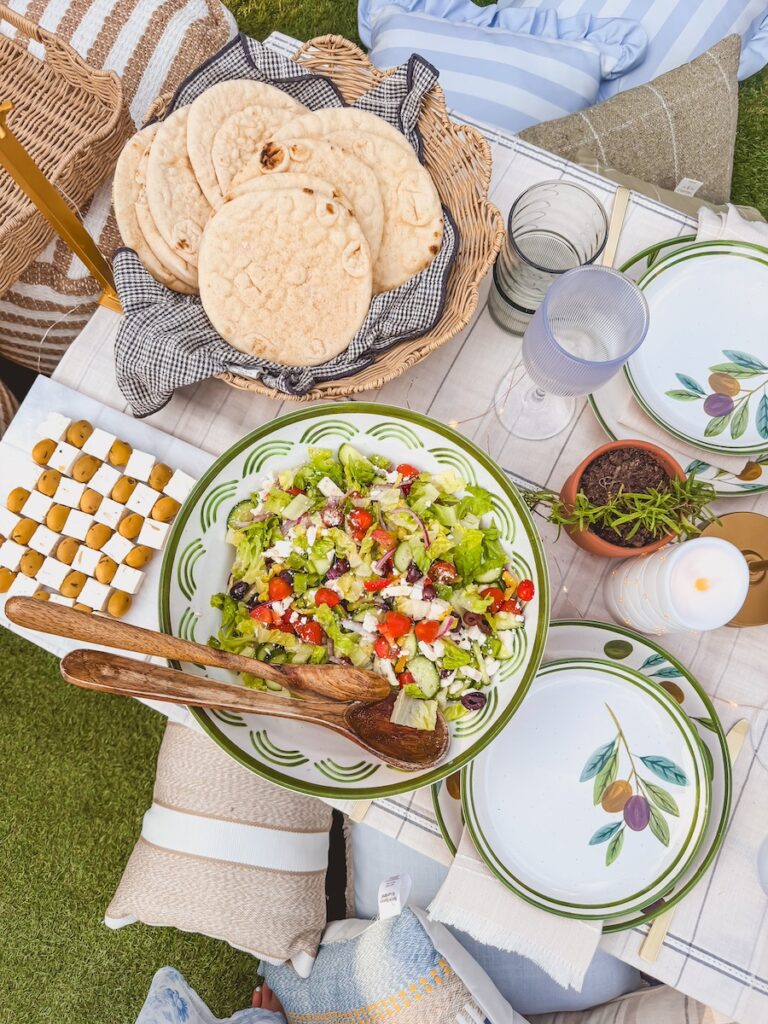 close up of greek salad and feta cheese appetizer on outdoor dinner party table