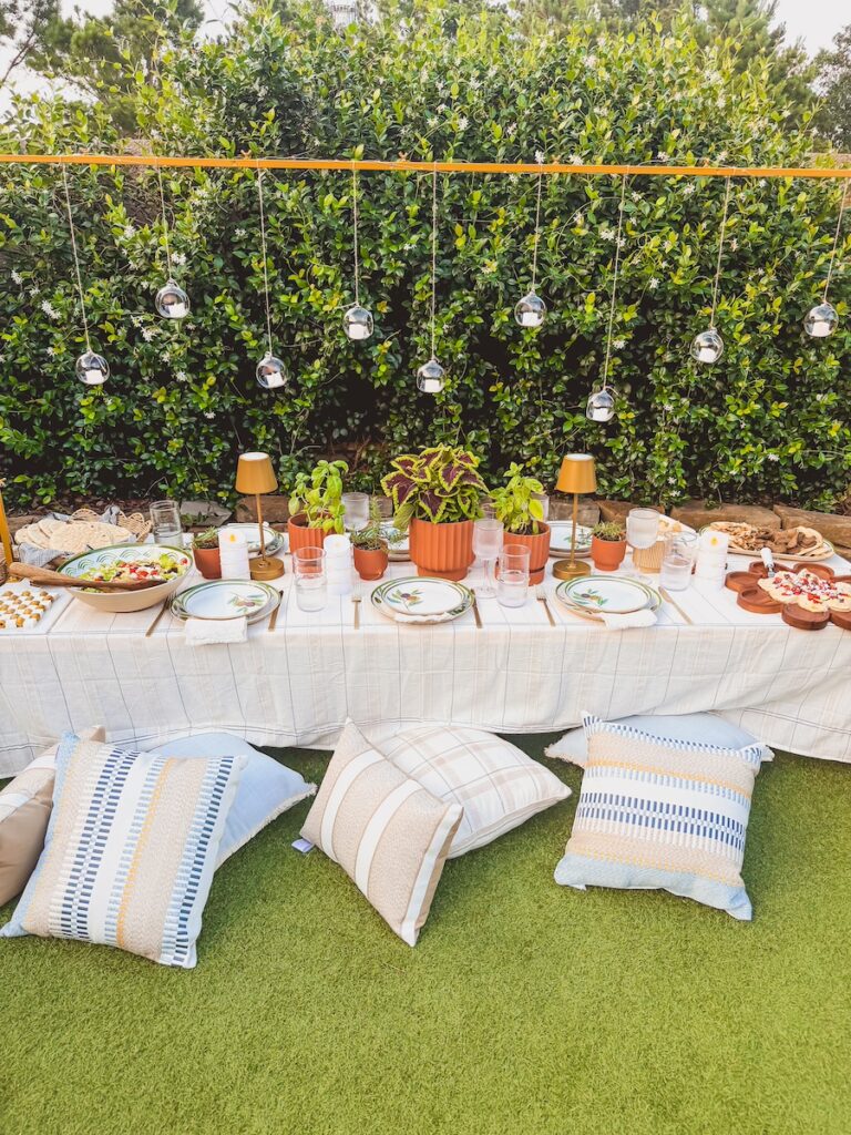 outdoor pillows for seating around picnic table for summer party idea