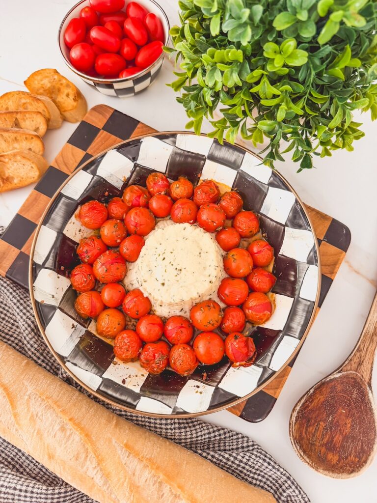 boursin and tomatoes out of the oven in baking dish with crostini