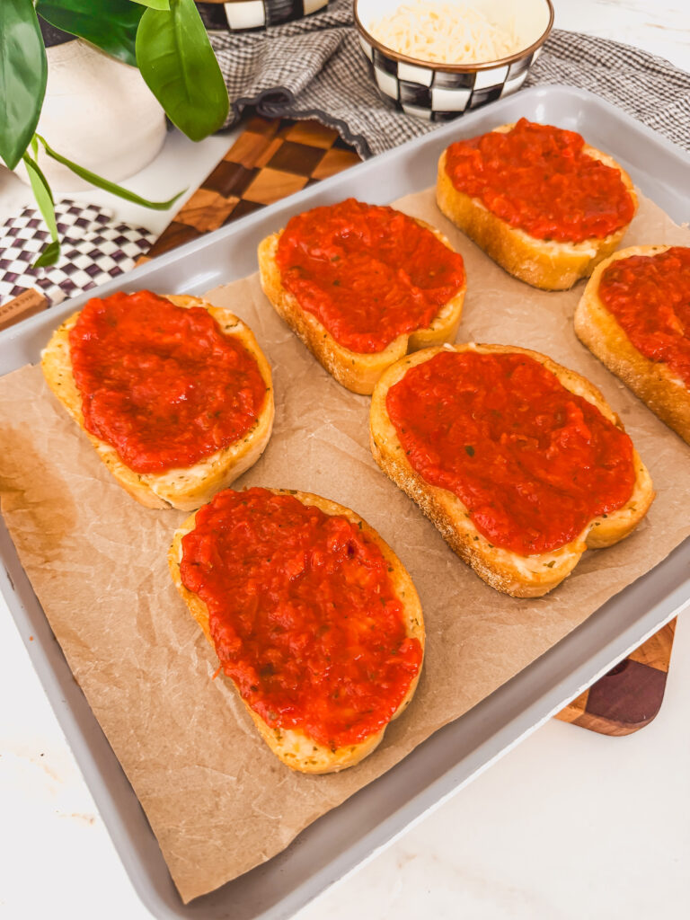 toasts on sheet tray topped with sauce