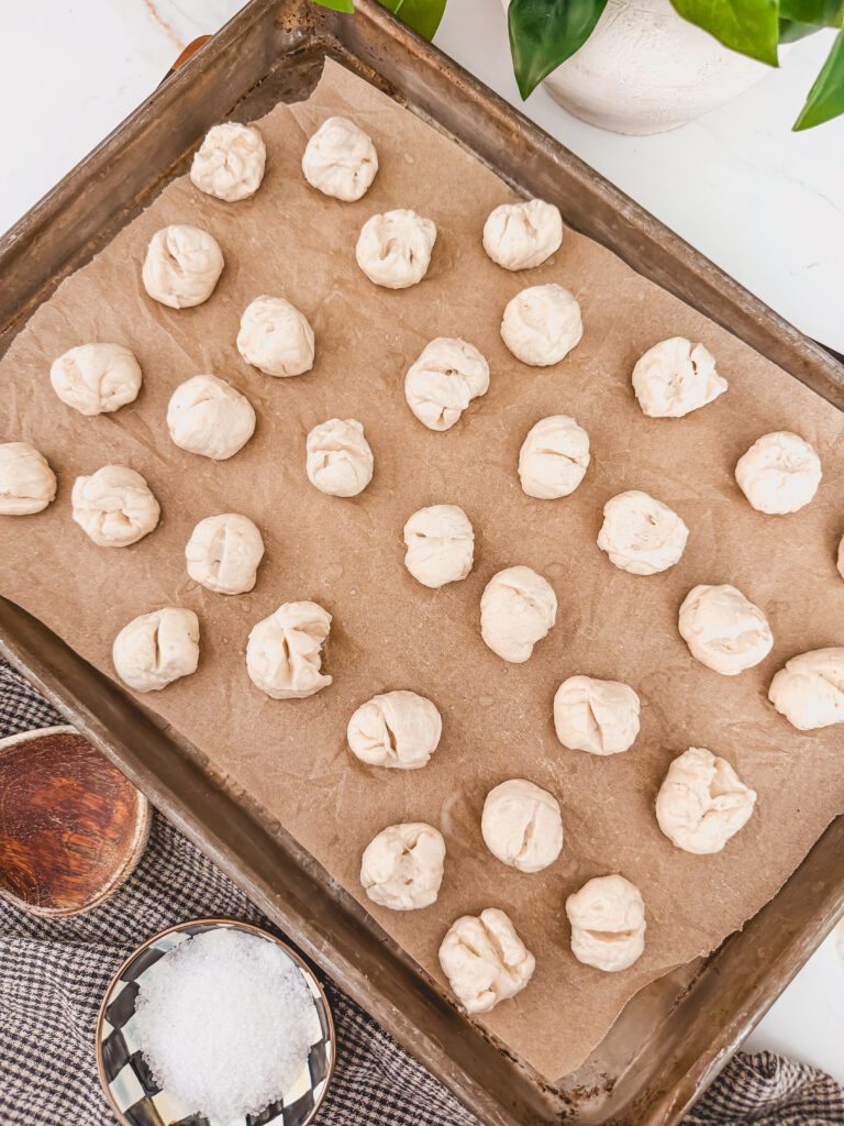 biscuit dough balls that have been soaked in baking soda on sheet tray.