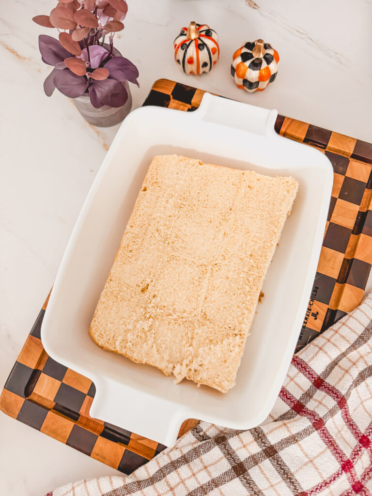 A white baking dish with the bottom half of the buns.