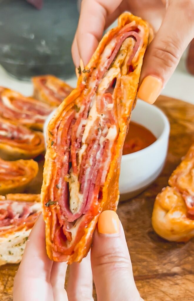close up holding italian stromboli