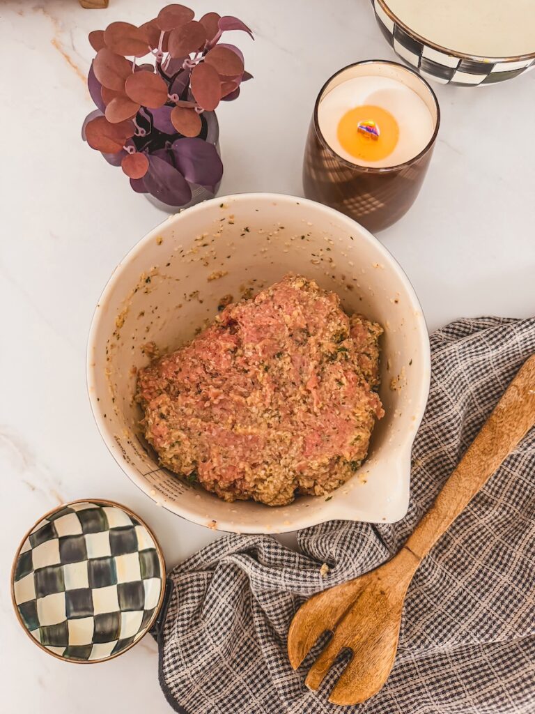 raw turkey mixture in bowl ready to be scooped. wooden spoon and dish towel next to bowl.