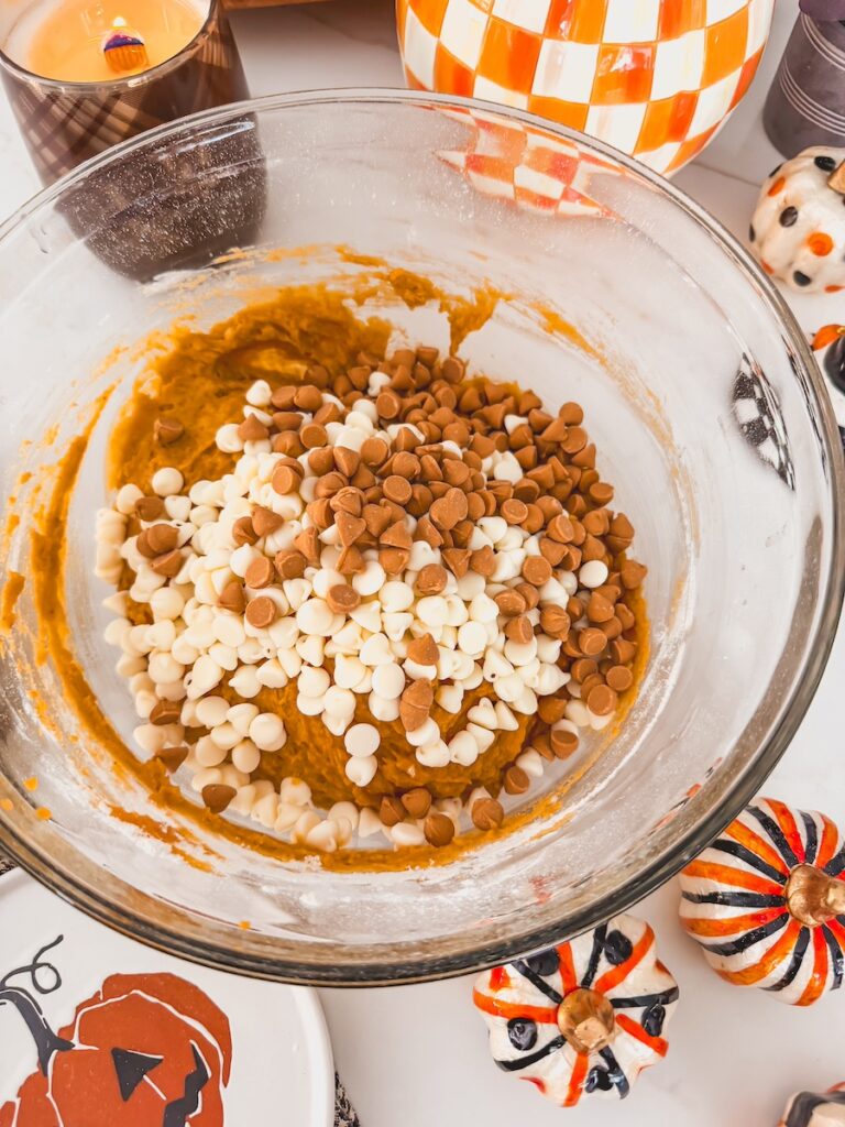 blondie batter in clear bowl with chips added in