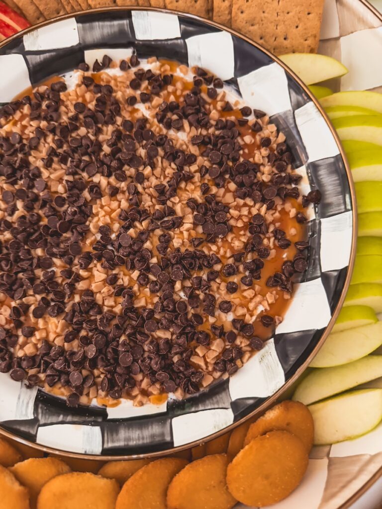 close up of caramel apple cheesecake dip with chocolate chips and heathbits