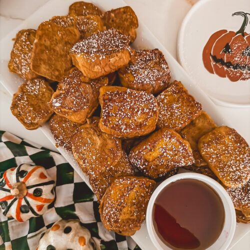 pumpkin french toast made with kings hawaiian rolls with maple syrup and powdered sugar