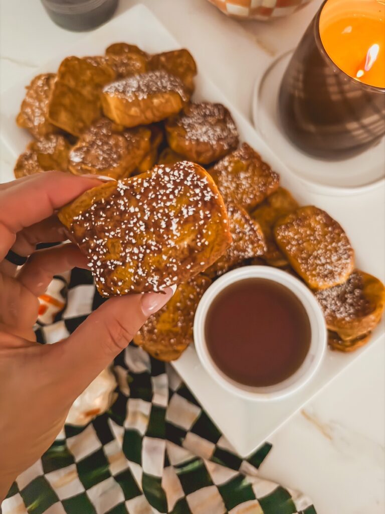 hand holding kings hawaiian pumpkin french toast made with pumpkin purree, milk, cinnamon, eggs, pumpkie pie spice