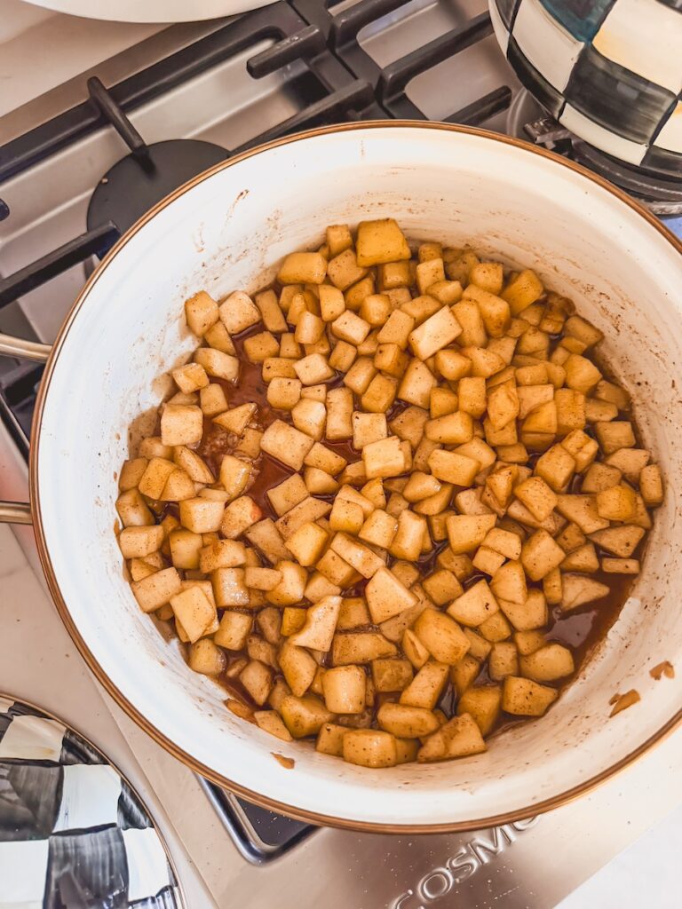 apple filling on stove top with brown sugar, butter, nut meg, cinnamon, all spice , maple syrup, cornstarch and vanilla extract