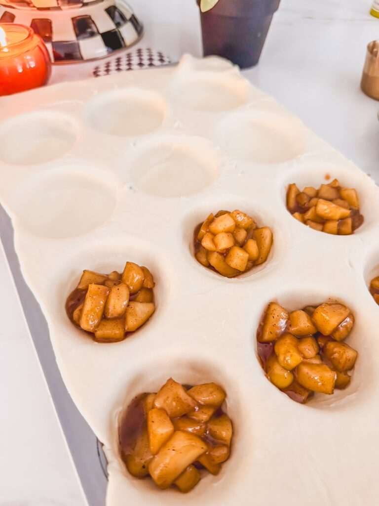 apple filling in each muffin cavity