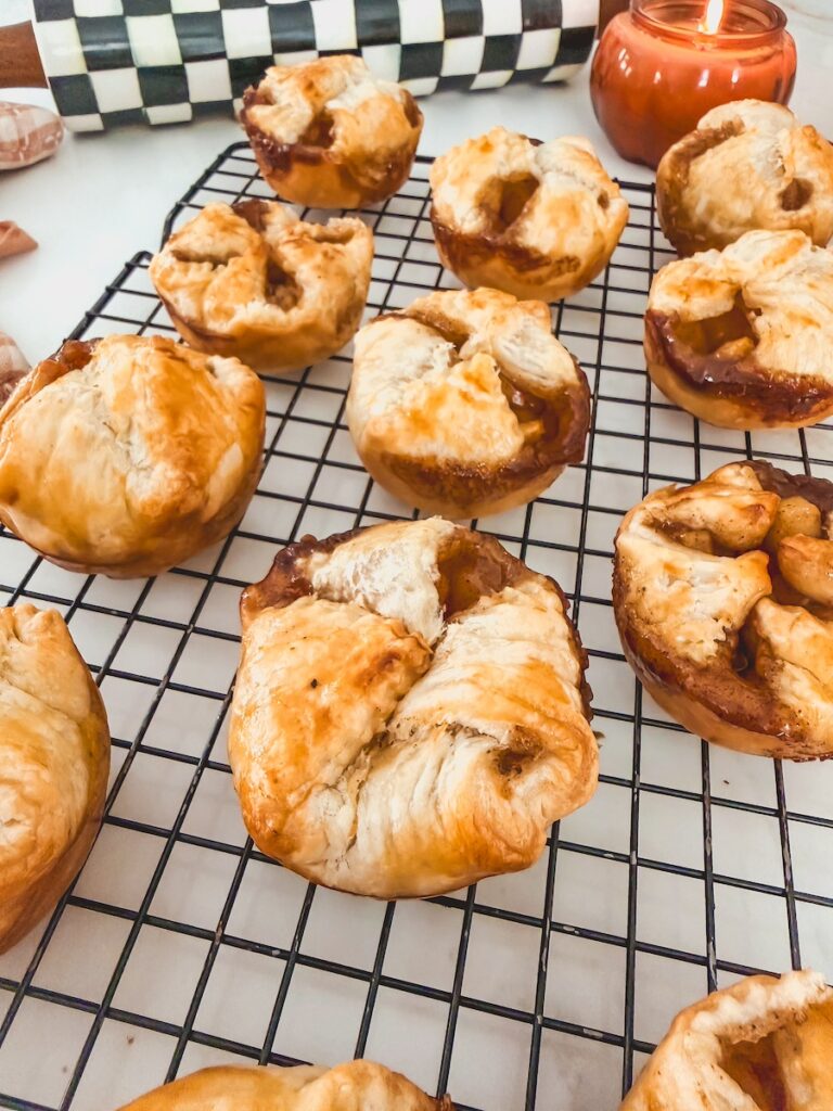 close up of apple pastries on cooling rack