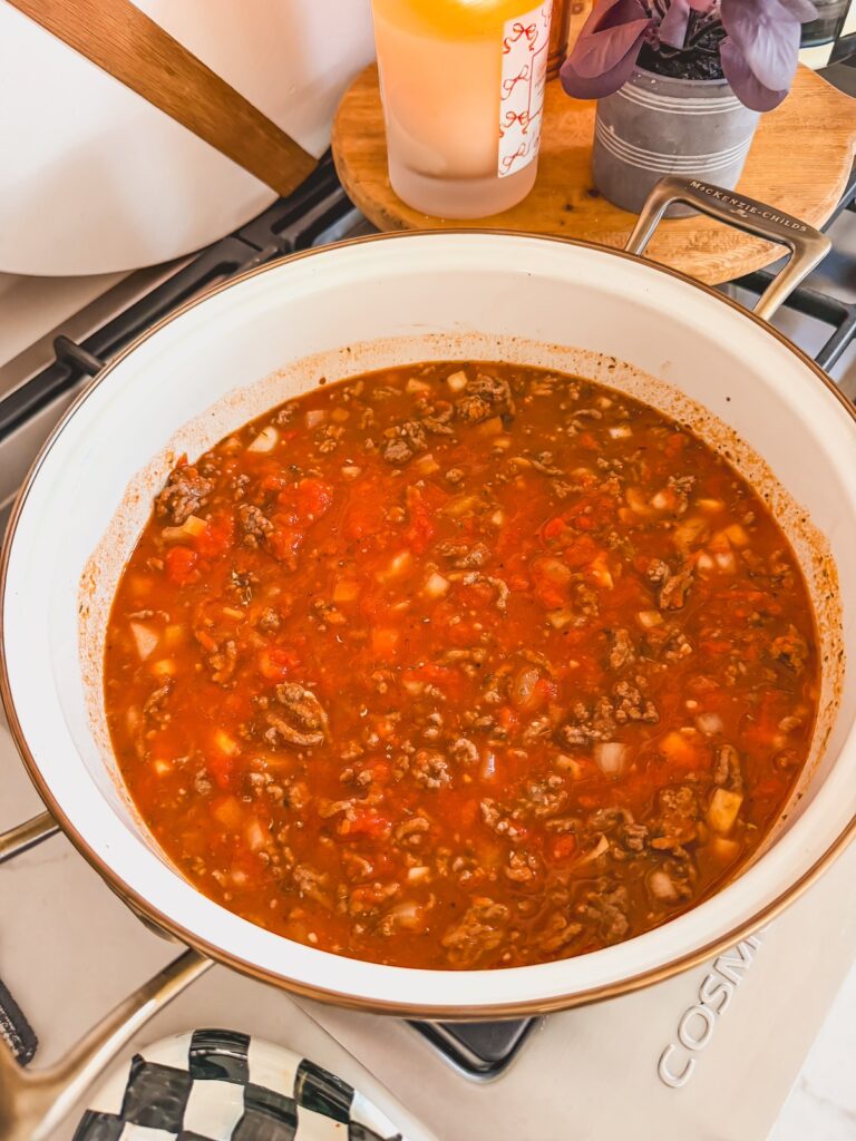 tomato sauce and water added to skillet with beef and spices