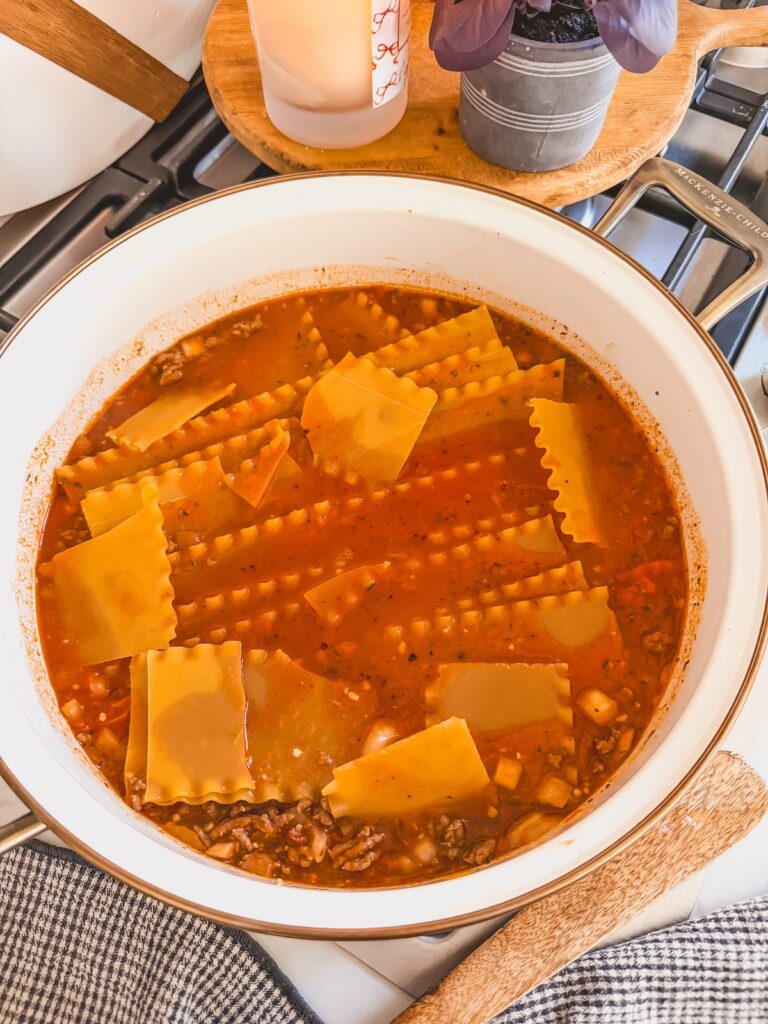 lasagna noodles added to skillet in meat sauce