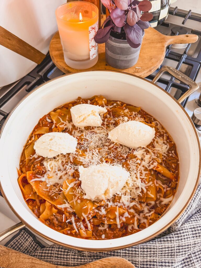 dollops of ricotta cheese added to lasagna skillet
