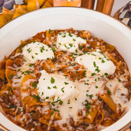 lazy one pan skillet lasagna in white deep skillet with ricotta cheese