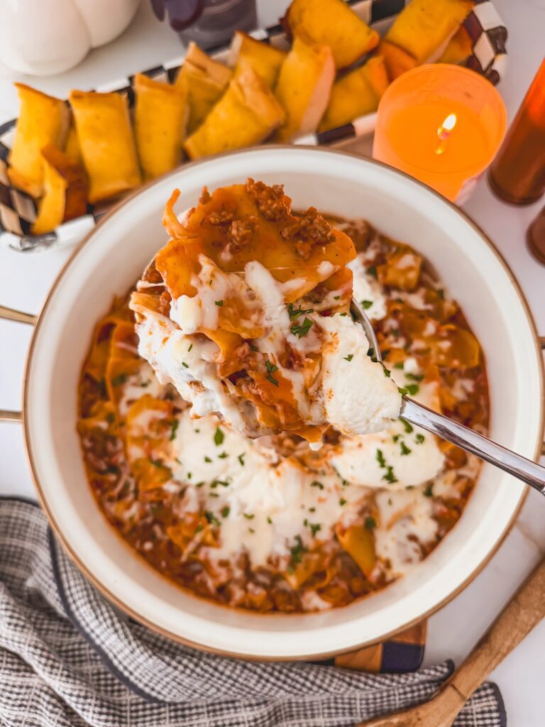 spoon full of lasagna with skillet 