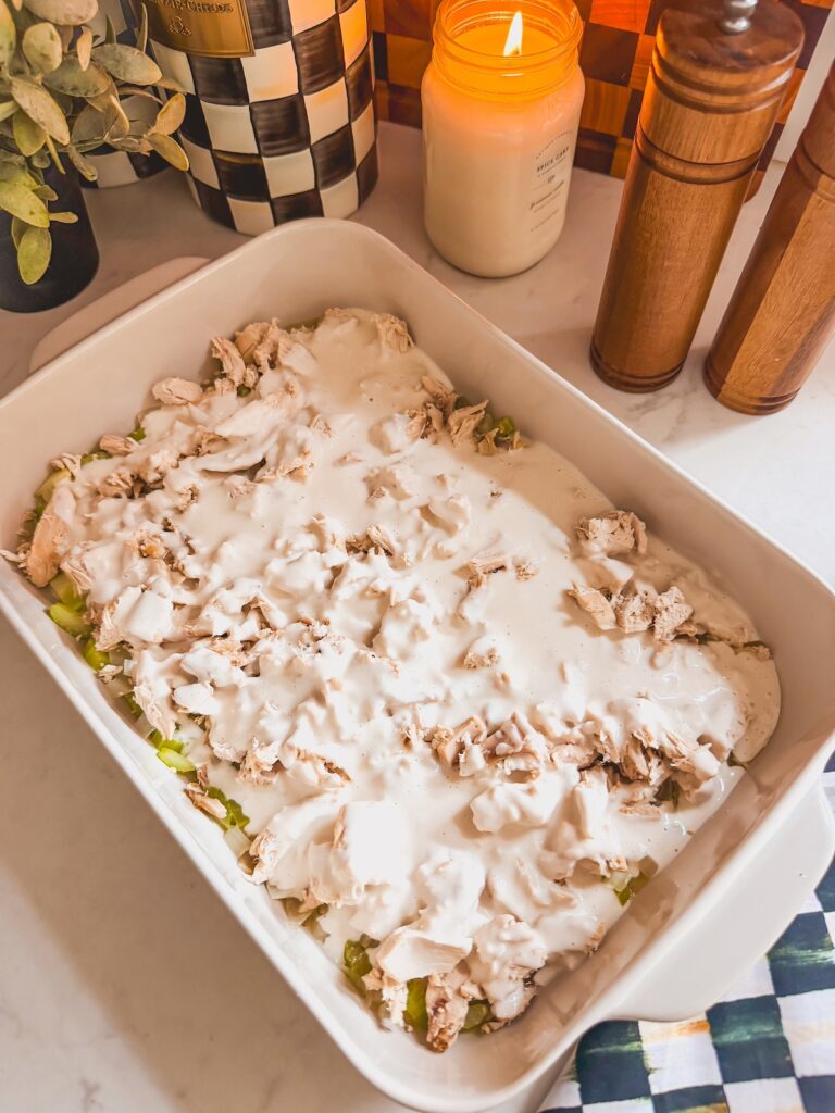 chicken topped with creamy sauce in baking dish