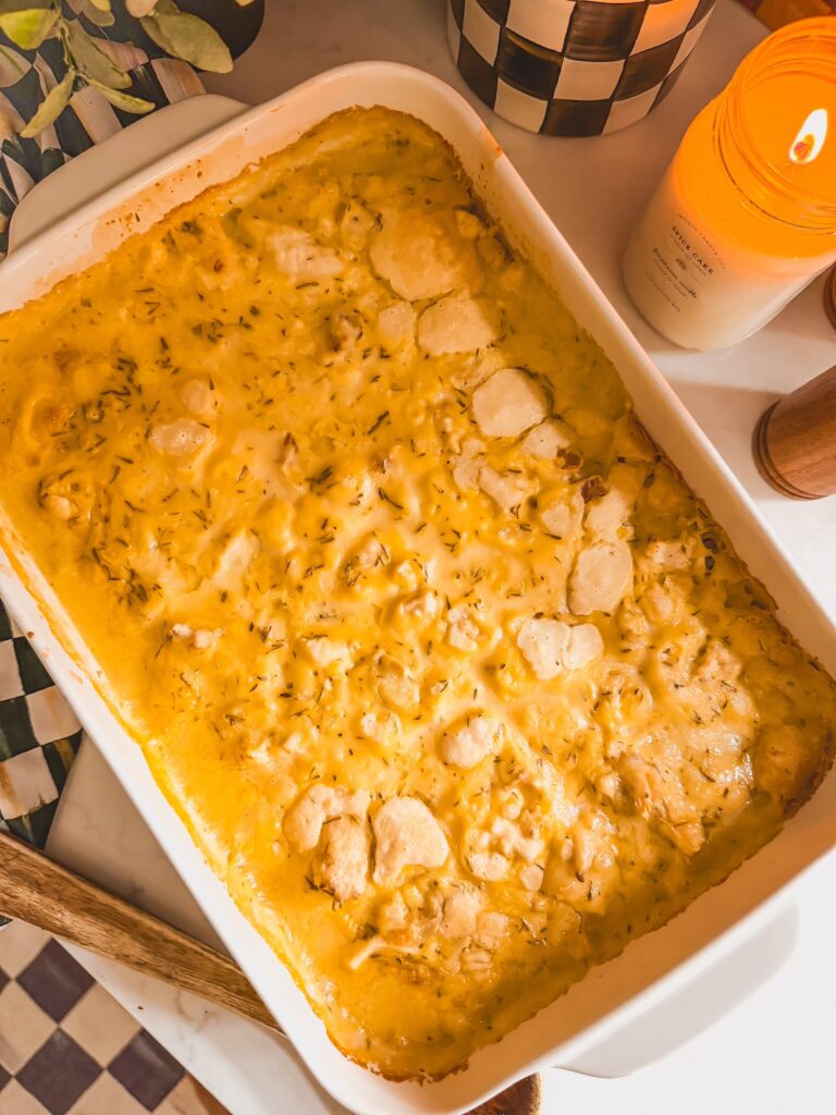 baked chicken, sauce and dumplings in white baking dish-overhead shot