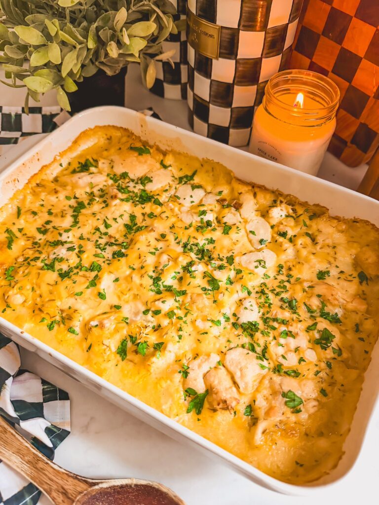 casserole dish of baked chicken and dumpling casserole with candle in background