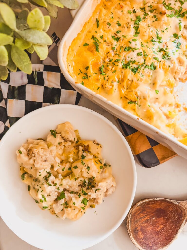 white bowl of casserole next to casserole dish