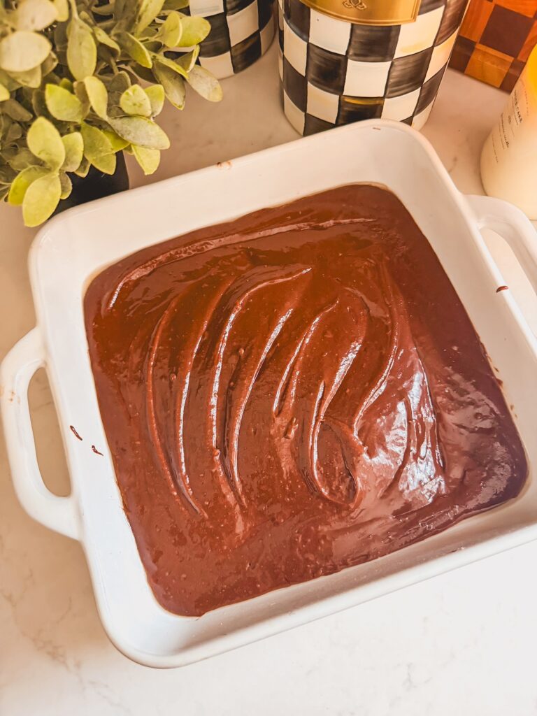 brownie mixture in white baking dish