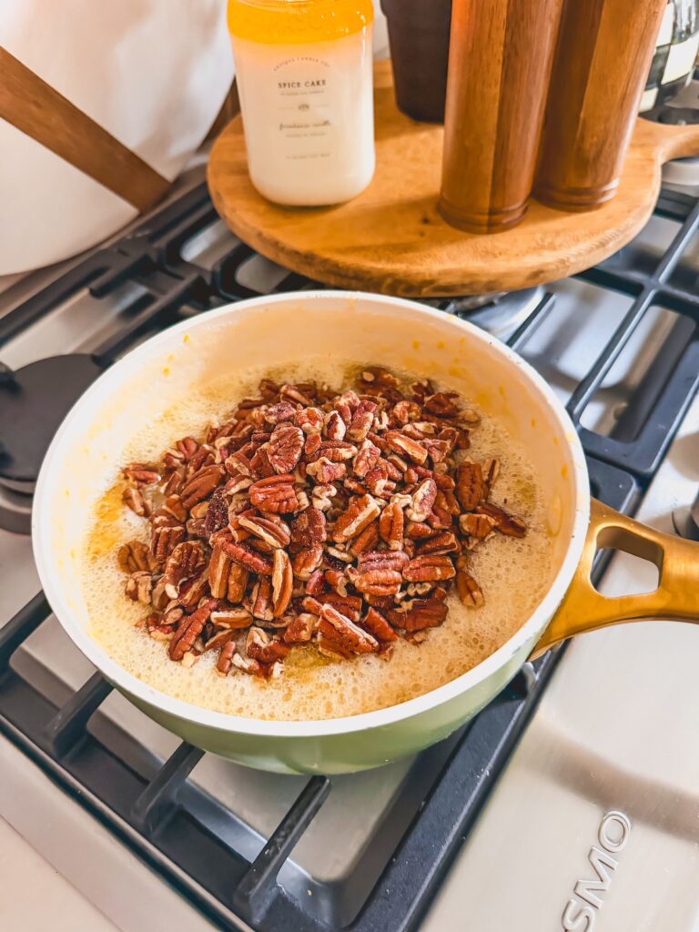 pecans added to pie fillnig mixture on stove in pot