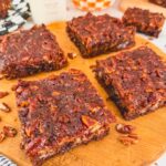 4 brownies on a wooden board