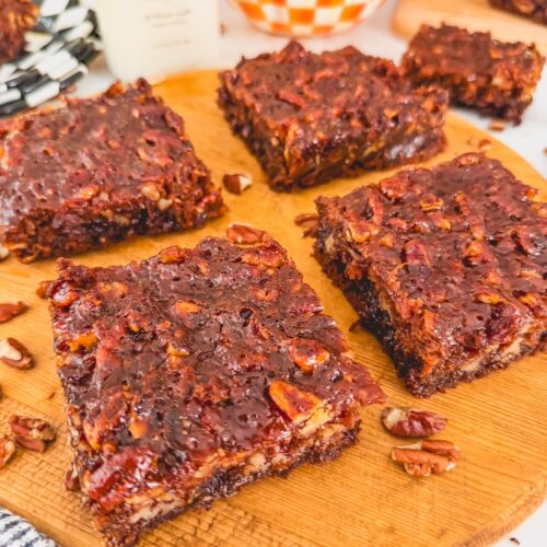 4 brownies on a wooden board