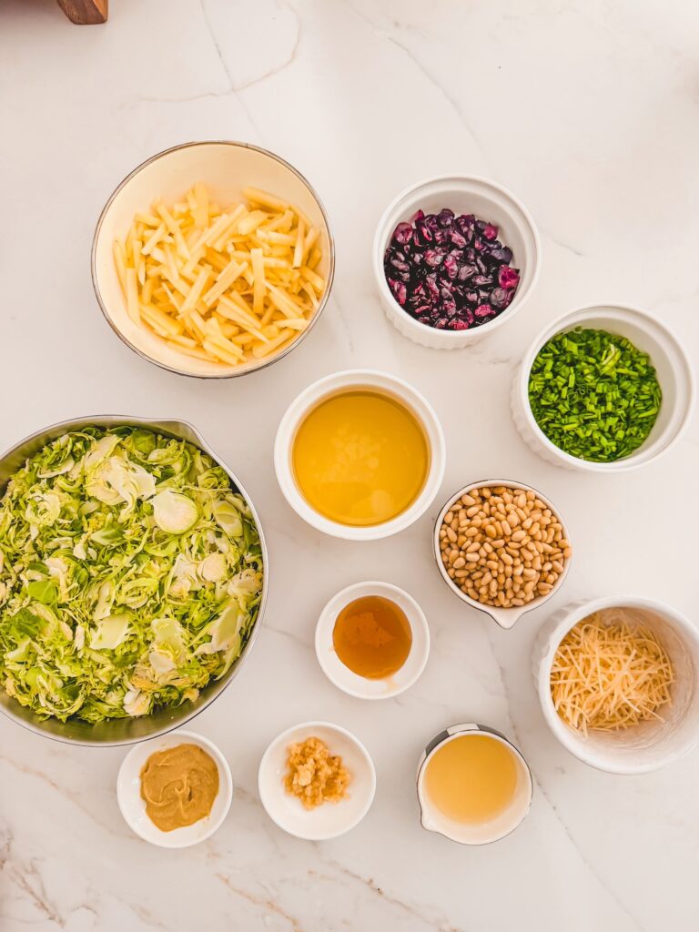 shaved brussels sprouts salad ingredients on white counter