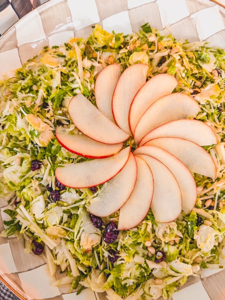shaved brussels sprouts salad with fanned apple on top
