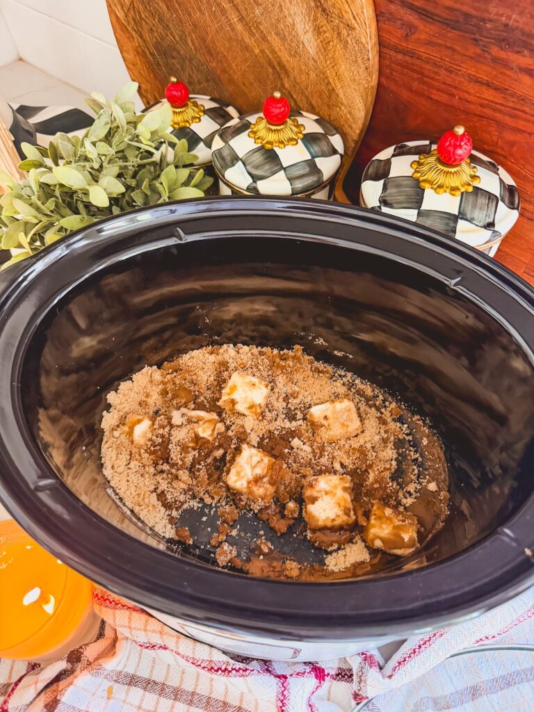 butter brown sugar mixture in bottom of slow cooker