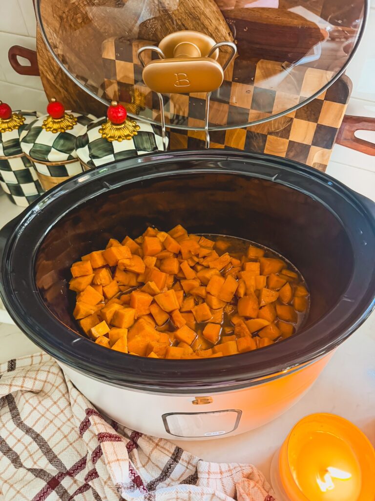 cooked sweet potatoes in bottom of slow cooker