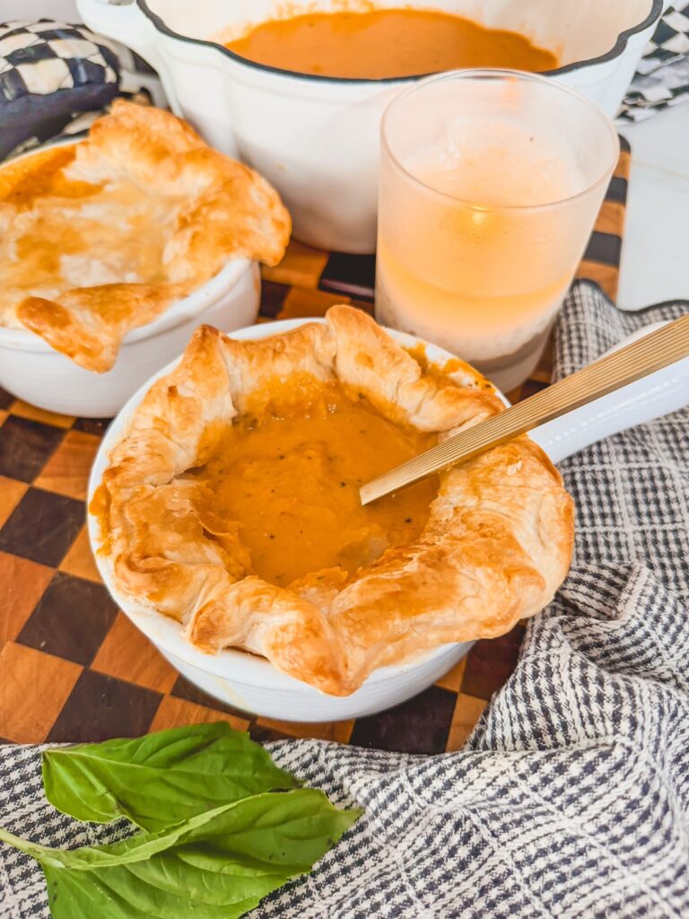 spoon in the middle of puff pastry roasted tomato soup