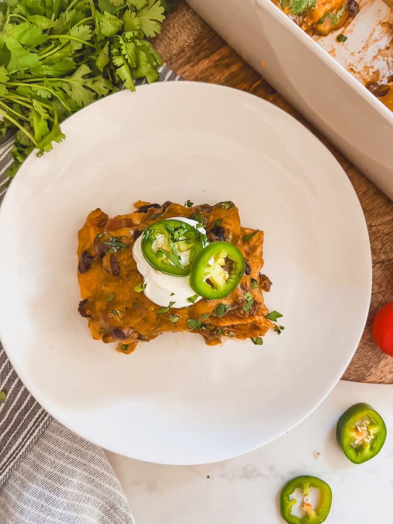 plate of taco casserole with sour cream and jalapenos