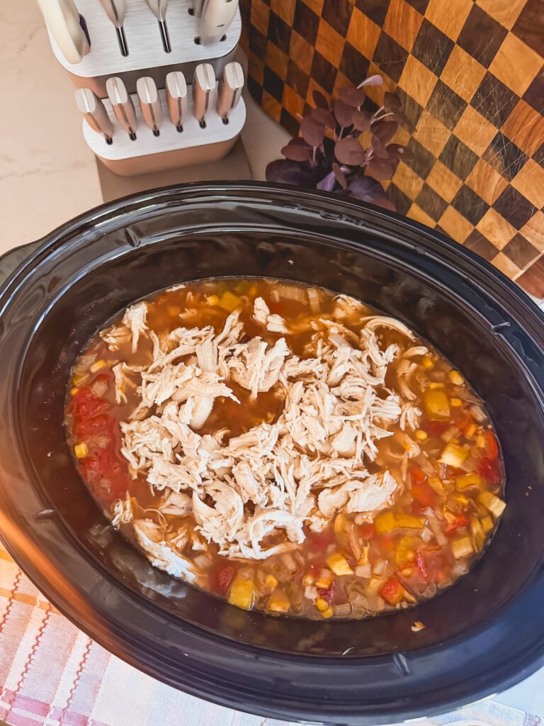 chicken shredded and added back into the chicken tortilla soup in the slow cooker